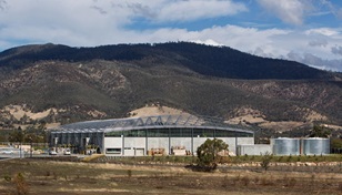 The roof made from COLORBOND® steel is suspended below the curving roof trusses, which reduced the external wall area by about 900m2 to achieve significant cost savings.
